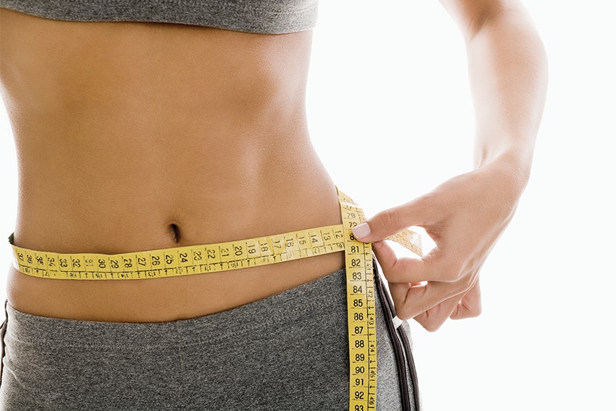 Body fat Woman measuring her waist