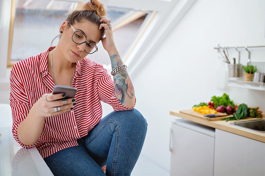 Woman Uninterested in Eating Woman on phone uninterested in eating