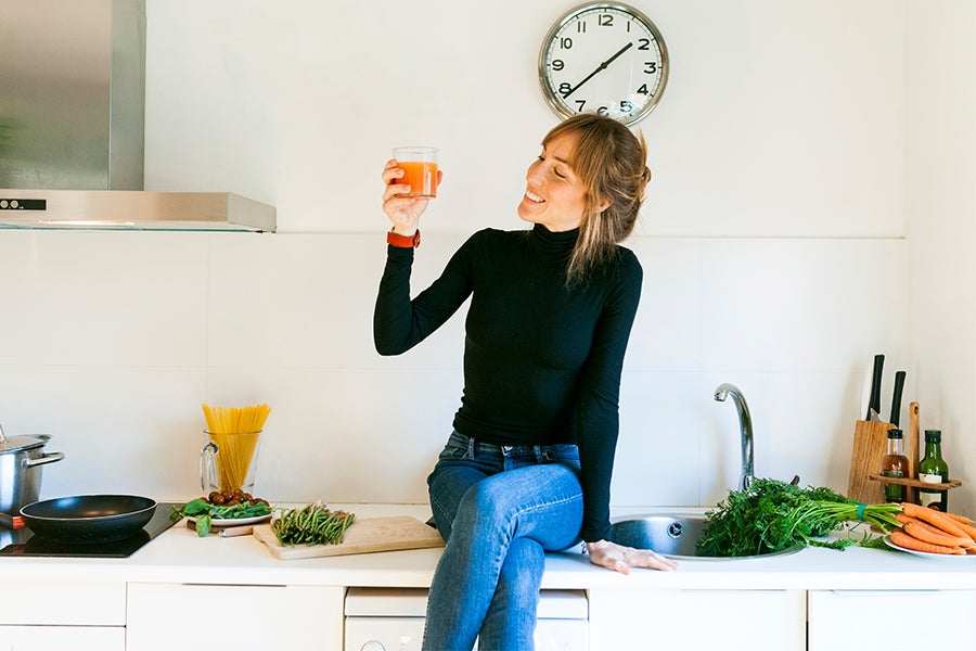 Meal Time Woman drinking vegetable fruit juice in kitchen