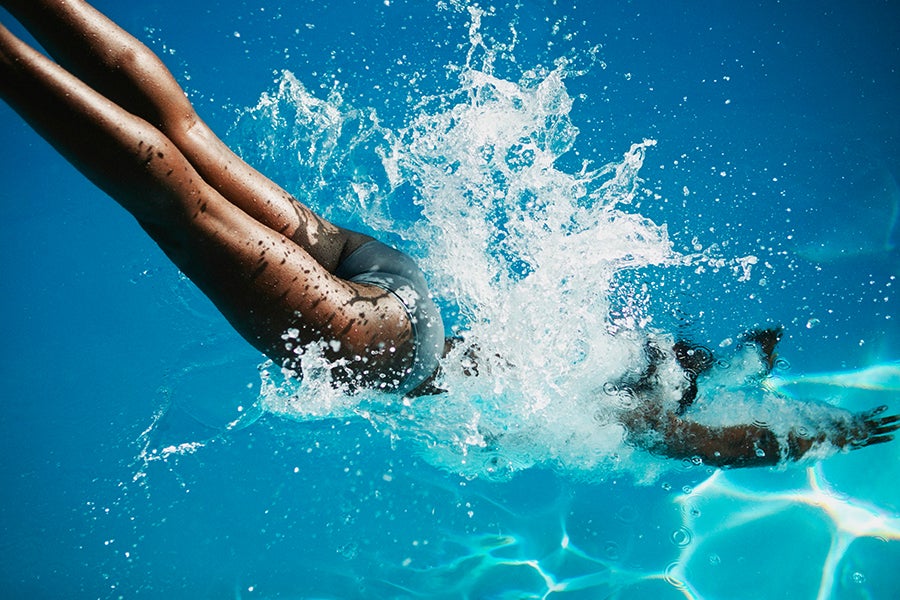 Swimming in water Woman jumping into the ocean