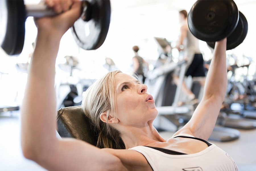 Woman Lifting Weights Woman breathing while strength training