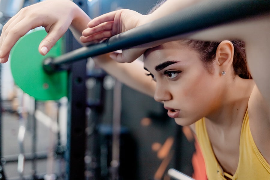 Promo Image Woman obsessing over weight in the gym
