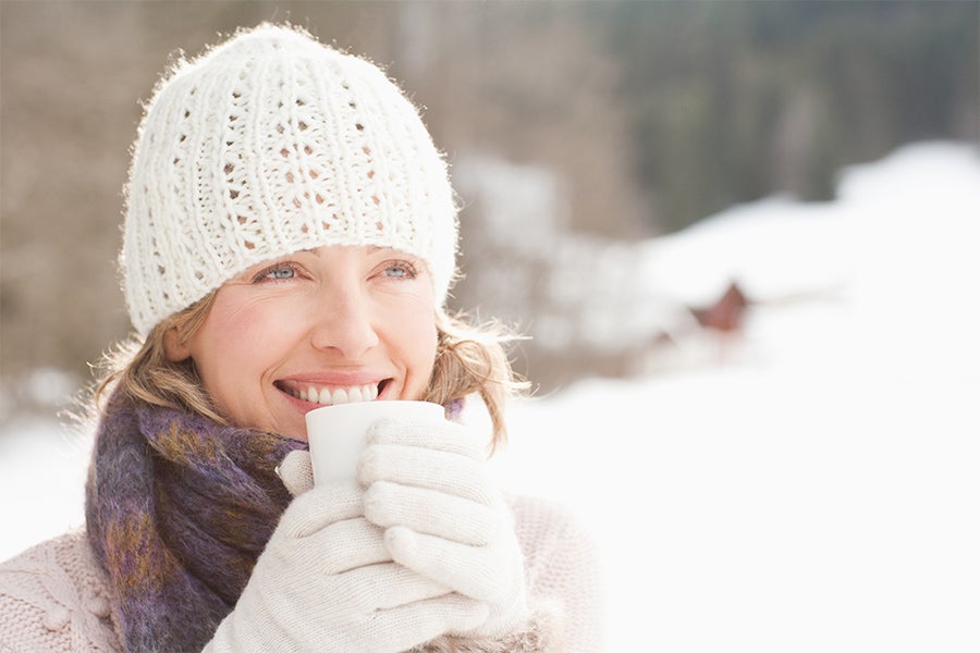 Holiday Fatigue Woman smiling outdoors in the winter