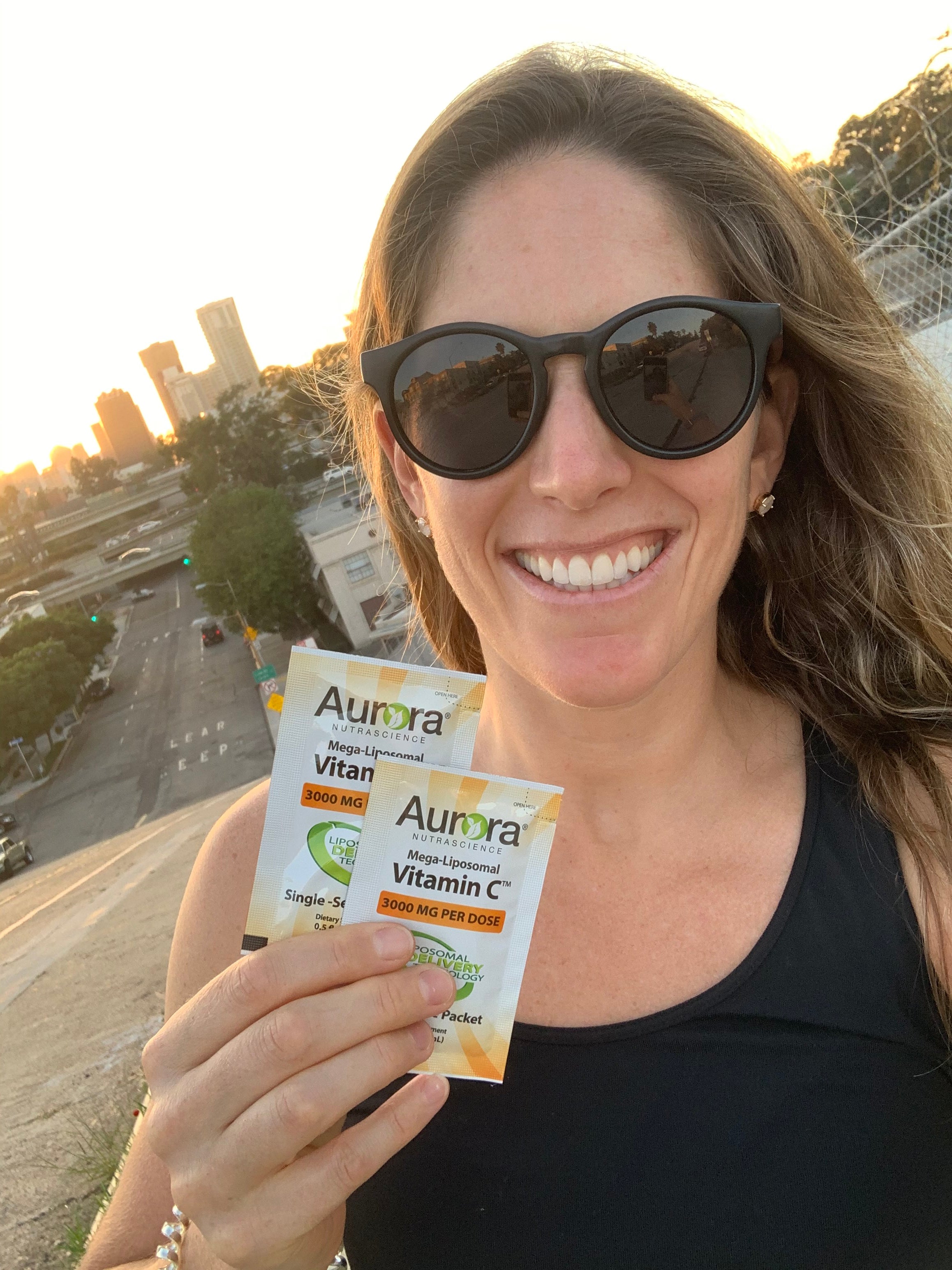 Andrea Chapin Andrea Chapin standing outside while holding vitamin C packets