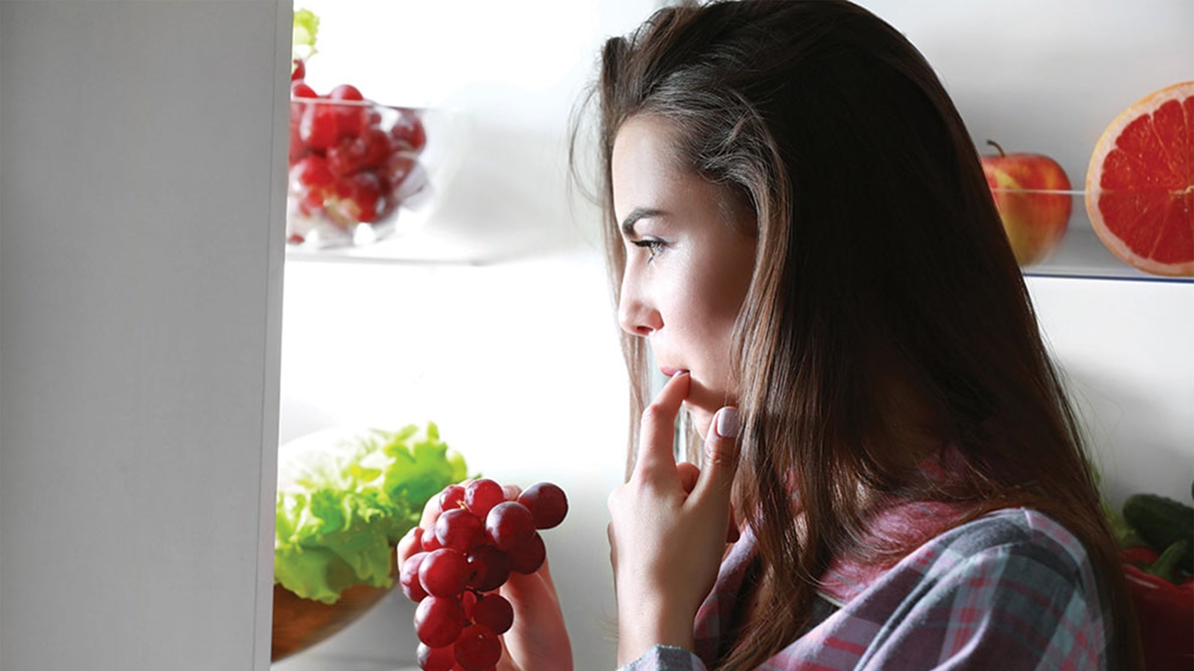 Woman looking into the fridge.