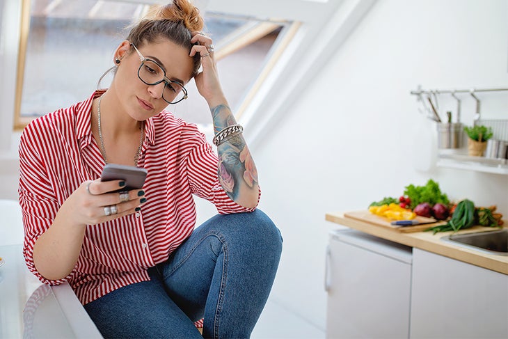 Woman Uninterested in Eating Woman on phone uninterested in eating