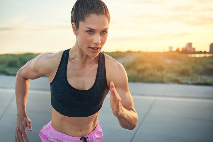 brain-train Fit woman outdoors in running stance