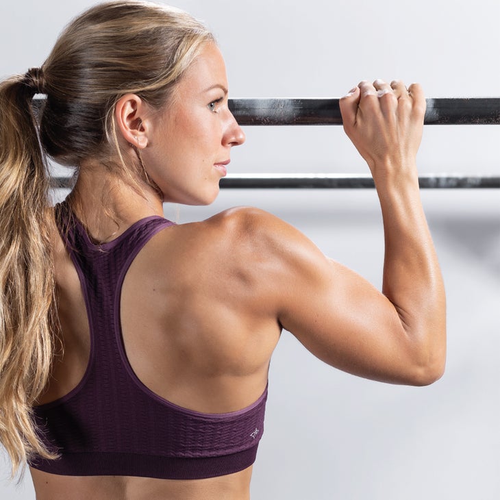 The Essential Six Woman doing a pull up