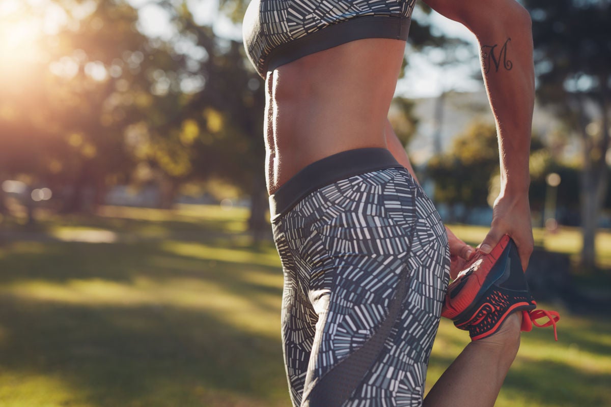 Woman with abs stretching