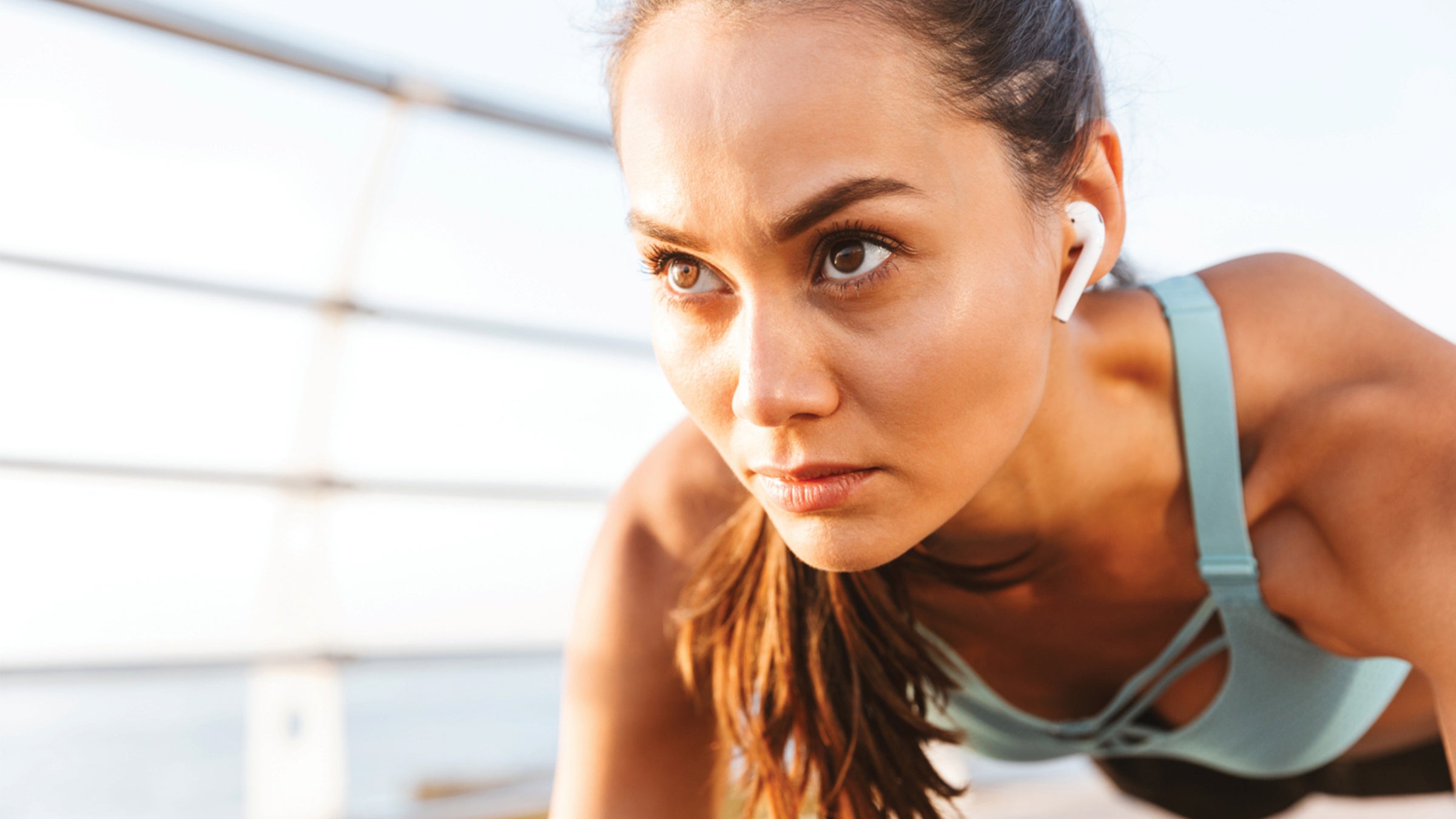 Fit woman doing a plank outdoors.