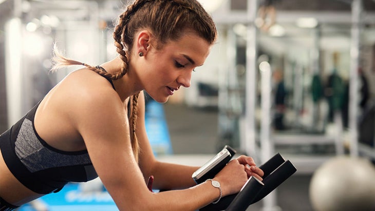Woman spinning on bike in home gym