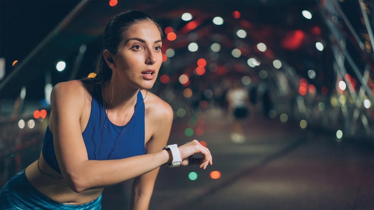 Woman training with a wearable fitness tracker