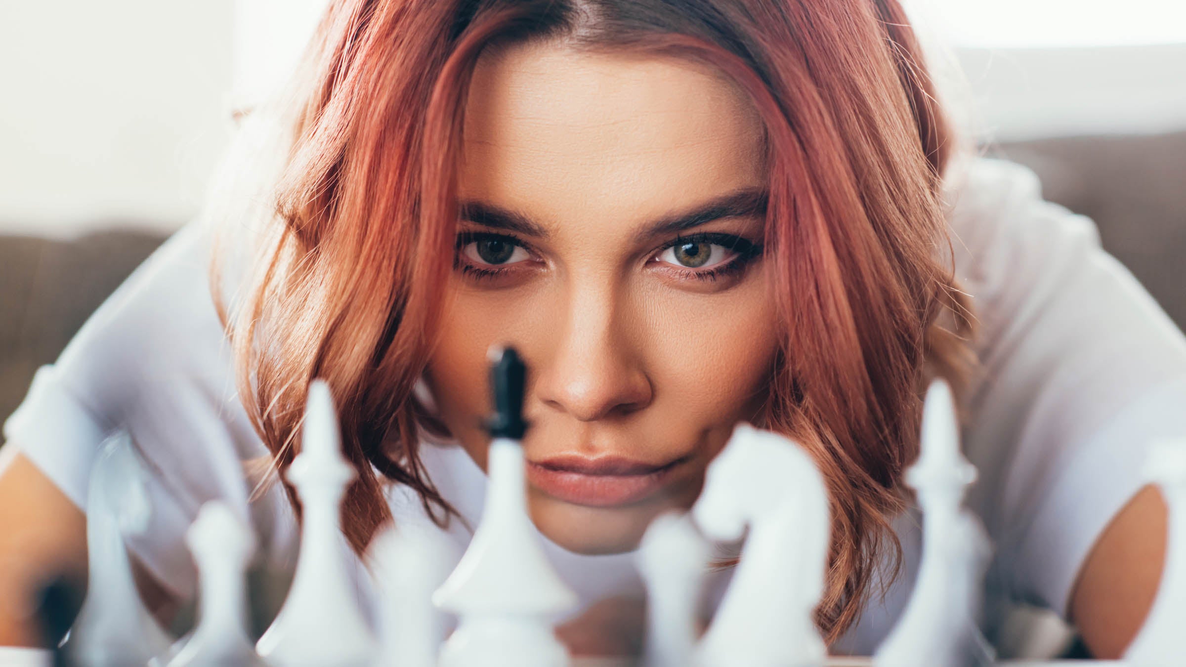 Girl concentrating on playing chess