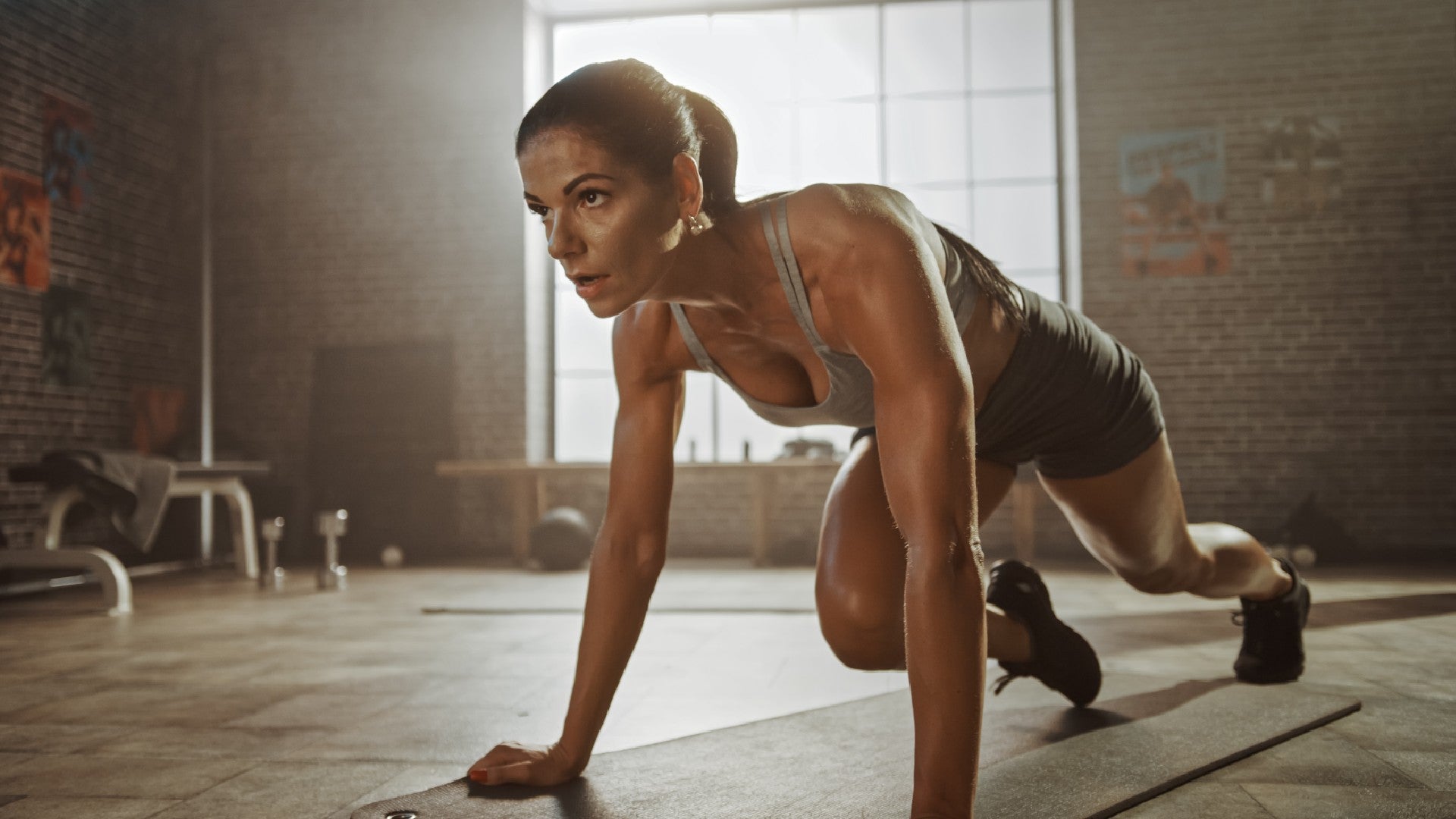 Woman Performing Mountain Climbers Cardio Workout