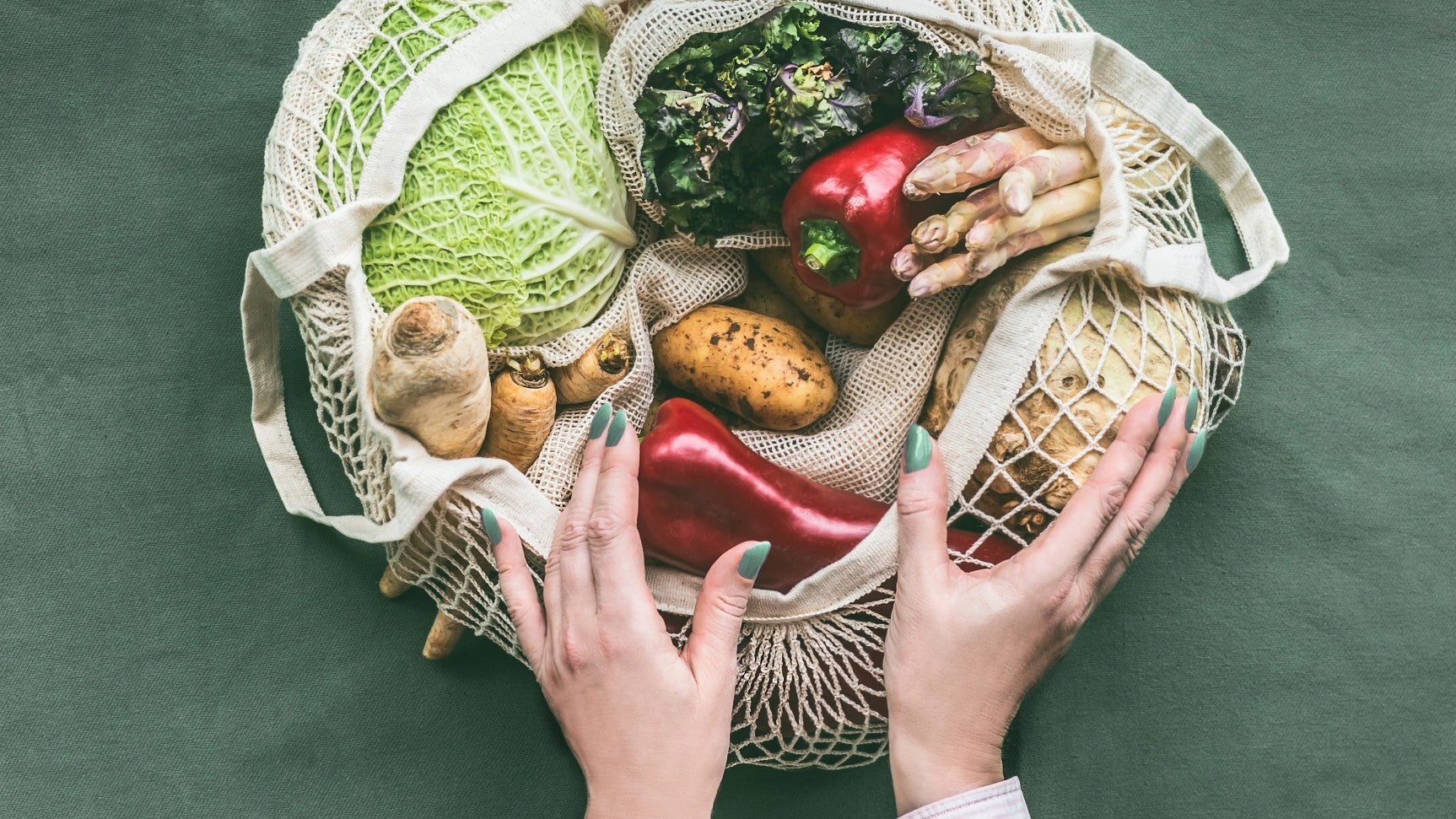 Women holding bag of vegetables