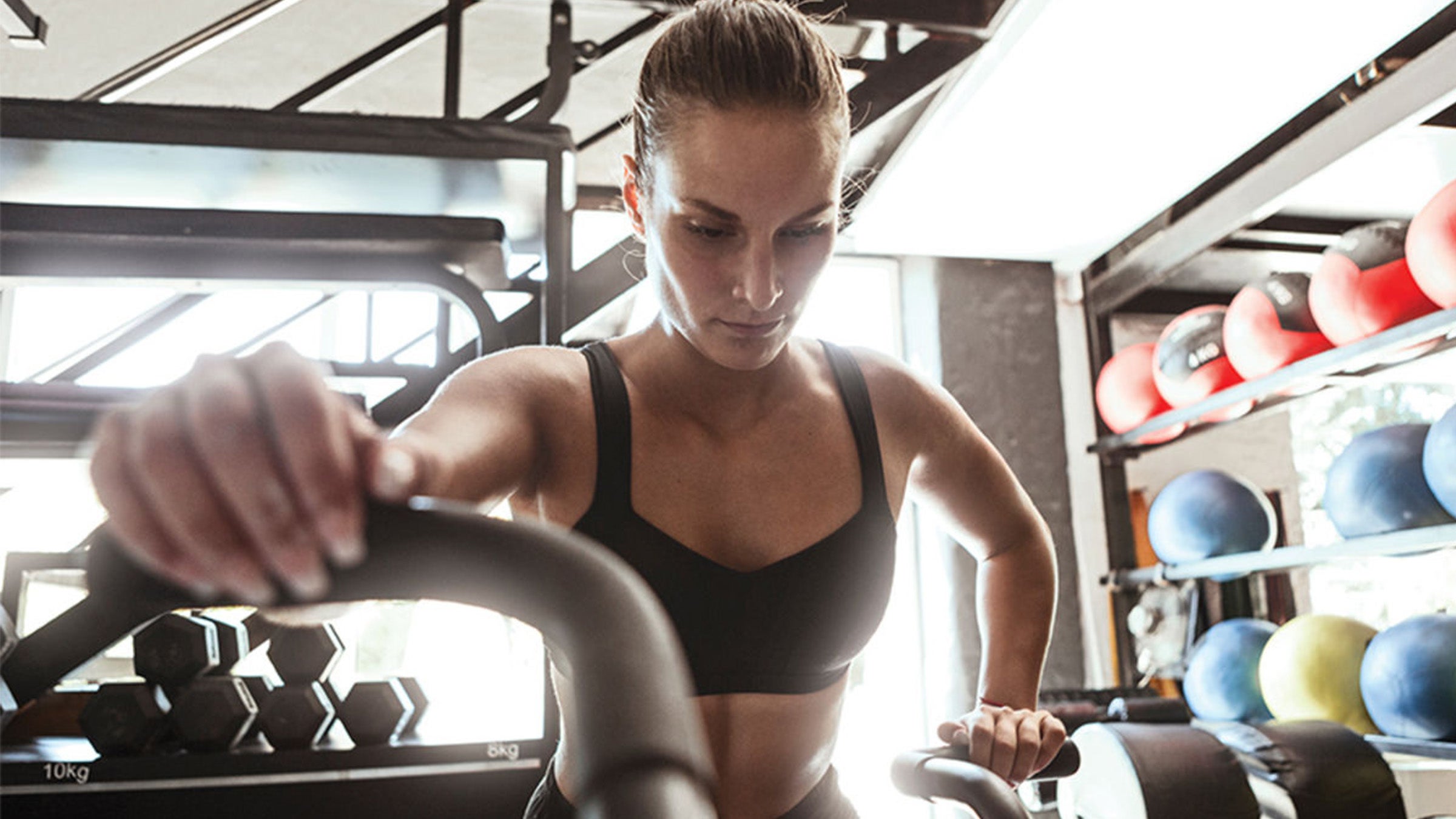 Woman biking in home gym