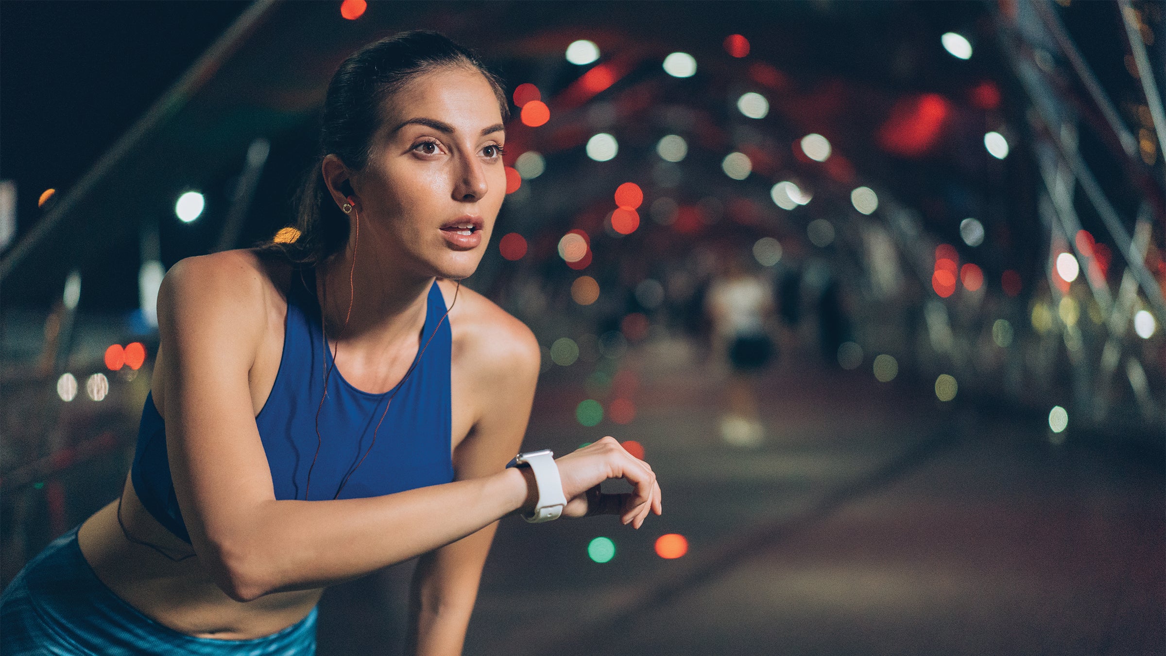 Woman training with a wearable fitness tracker